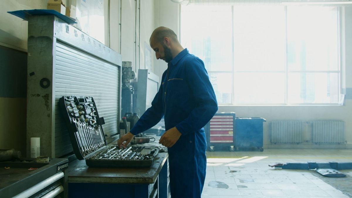 Technician checking a tool chest in a bright workshop