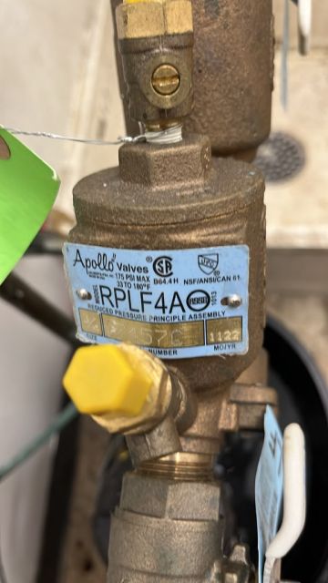 Close-up of the backflow assembly's relief valve and data plate