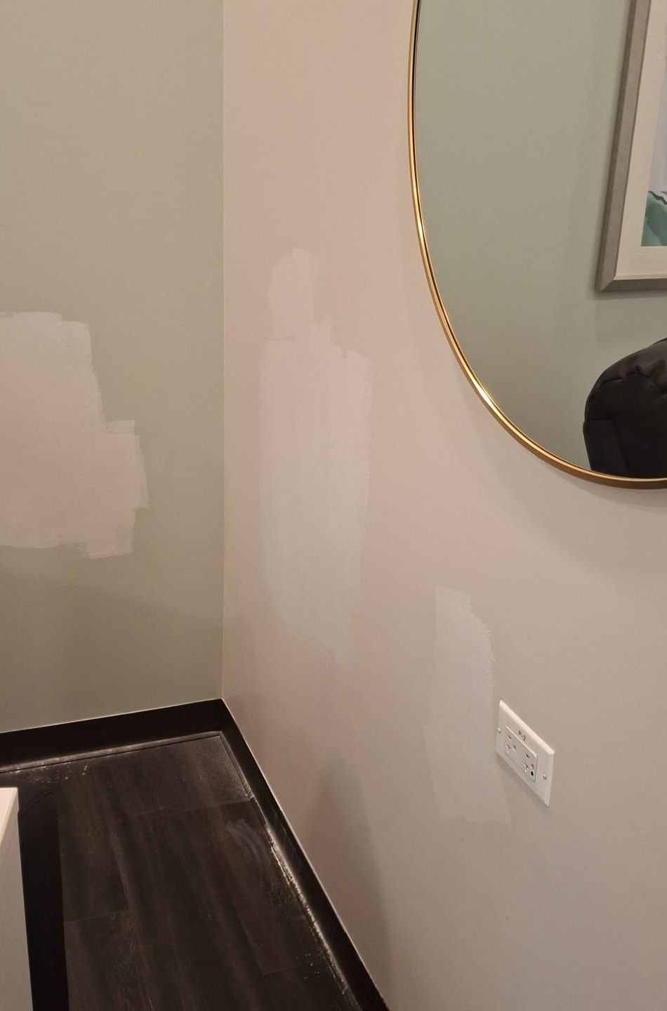 Patched spots across a patient room wall before painting