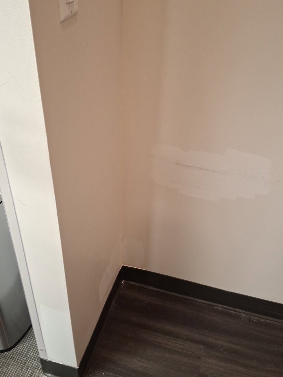 Patched wall beside a door frame