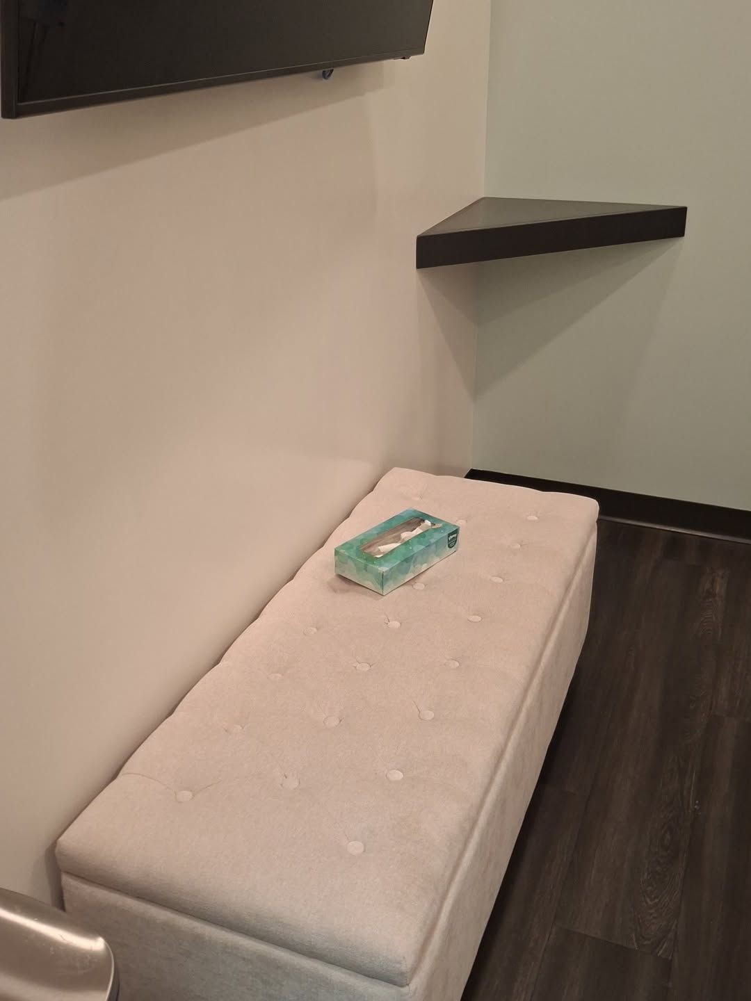 Finished patient room wall with a bench below a shelf