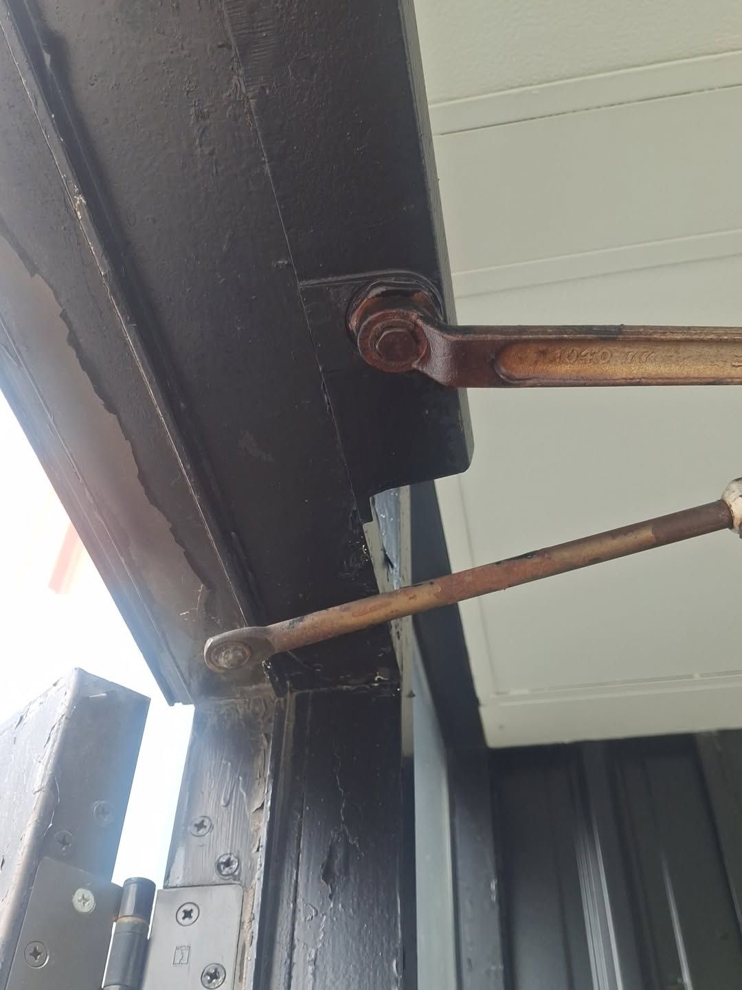 Window arms and brackets on a storefront frame